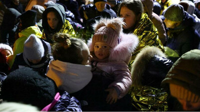 Des femmes et des enfants constituent dans la ville frontalière polonaise de Medyka, le 7 mars 2022. Crédit : Reuters