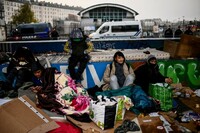 Des migrants attendent d’embarquer dans des bus pour un abri temporaire lors de l’évacuation de leur campement à Paris, le 17 novembre 2022. CHRISTOPHE ARCHAMBAULT / AFP